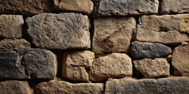 Close-up of an old stone wall with uneven, weathered bricks.