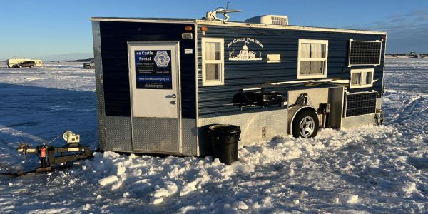 Ice fishing house on a frozen lake.