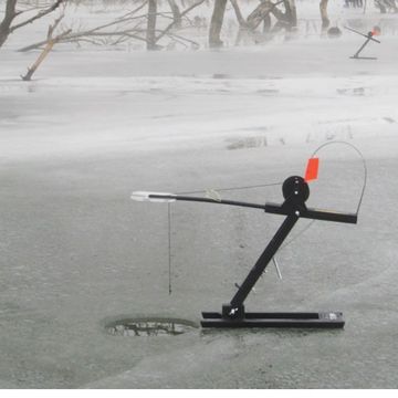 Ice fishing fishing tip-up on frozen lake.