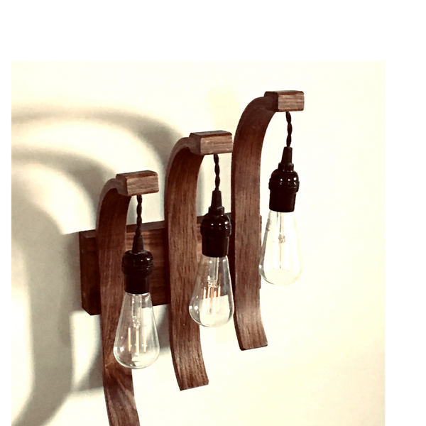 Bentwood laminated sconce light made of walnut.