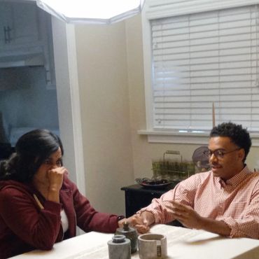 Couple having a serious conversation at a kitchen table.