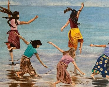 Children joyfully play and splash in shallow water by the beach.