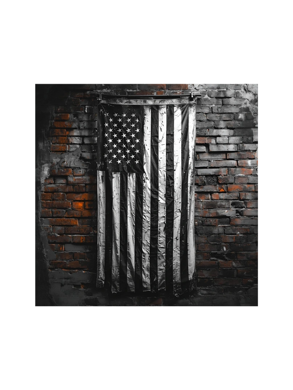 Black and white American flag hanging on a rustic brick wall.