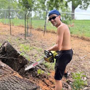 Kevin cutting wood log