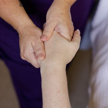 Hands massaging a hand for stress relief, improved circulation, and relaxation therapy benefits.