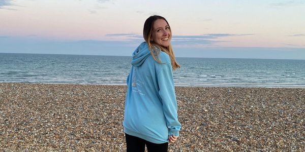 Nanny on the beach with sunset in background