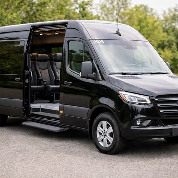 Black luxury Mercedes van with open sliding door showing leather seats.