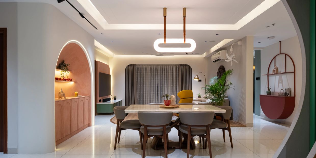 Modern dining room with unique lighting and stylish furniture.