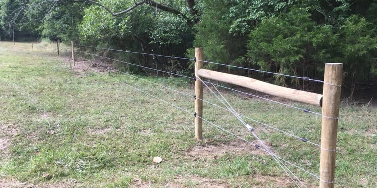 High tensile electric fence with wooden posts