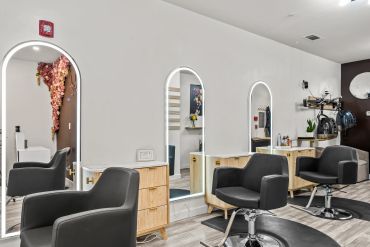 Modern salon interior with styling chairs and mirrors.
