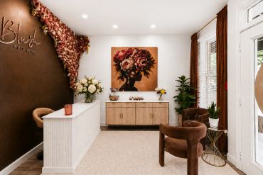 Elegant beauty salon interior with brown decor and floral accents.
