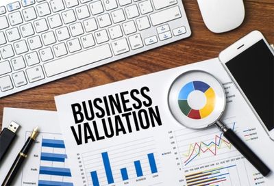 Image of charts, graphs, magnifying glass, and keyboard for Business Valuation Cpa, P.L.