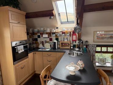 Cozy kitchen with wooden cabinets and skylight.