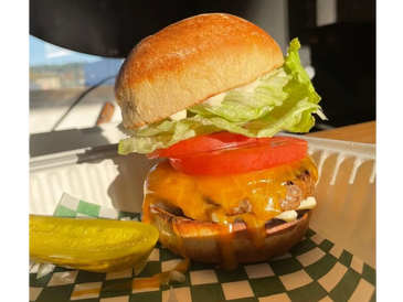 Classic Burger with Cheese standing tall and proud in the sunshine.