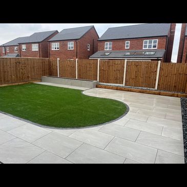 Quartz grey porcelain patio with anthercite cobble setts raised beds 