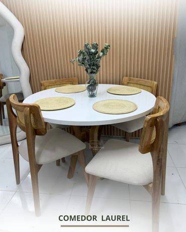 Modern dining set with white round table and wooden chairs.