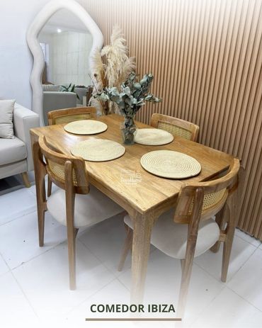 Modern wooden dining table with six chairs and decorative centerpiece.