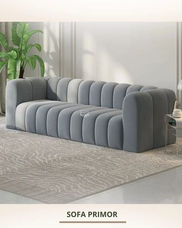 Contemporary gray sofa with rounded vertical cushions and modern design.