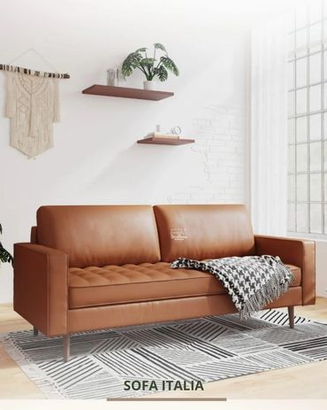 Modern brown leather sofa in a bright, minimalist living room.