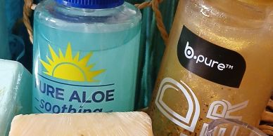 Aloe soothing spray, soap bars, and skincare products.