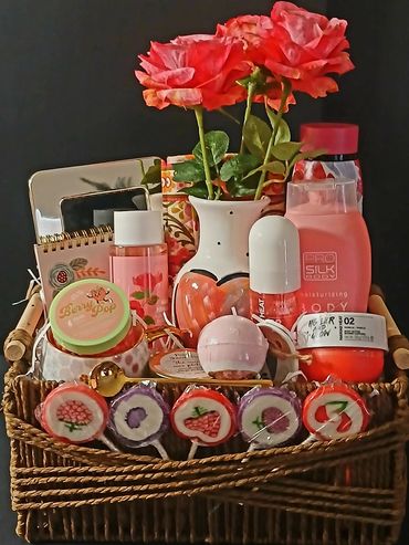 Basket filled with skincare products, roses, and colorful lollipops.