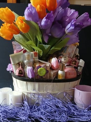Flower bouquet with assorted beauty products in a basket.