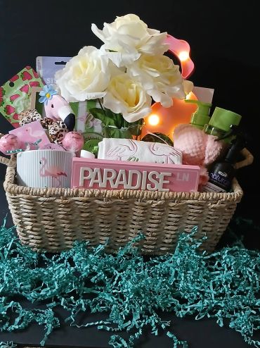 Decorative gift basket with flowers and bath items.