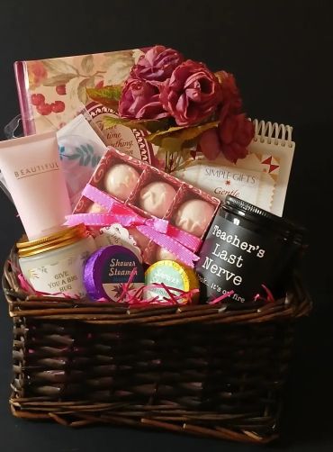 Gift basket with bath items and flowers.