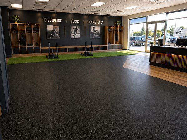 Modern gym entrance with motivational words and natural light.