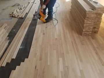Image of 3 1/4" white oak hardwood flooring being installed.