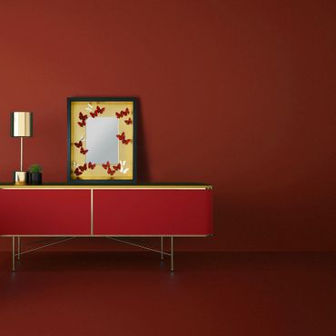 Chinoiserie butterfly gold framed mirror in red room. red lacquered sideboard credenza buffet table