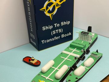 Model ships and a book on a table.