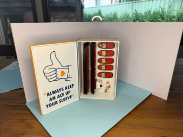 Box with poker-themed accessories and message.