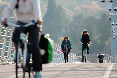 Bicyclists and pedestrians crossing the Tillikum Bridge over the Willamette River in Portland