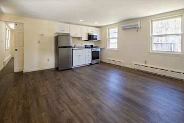 Kitchenette and living area for single bedroom unit