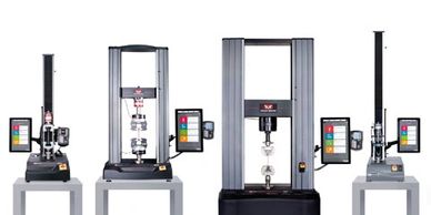 Four industrial material testing machines with digital displays, used for tensile and compression tests.