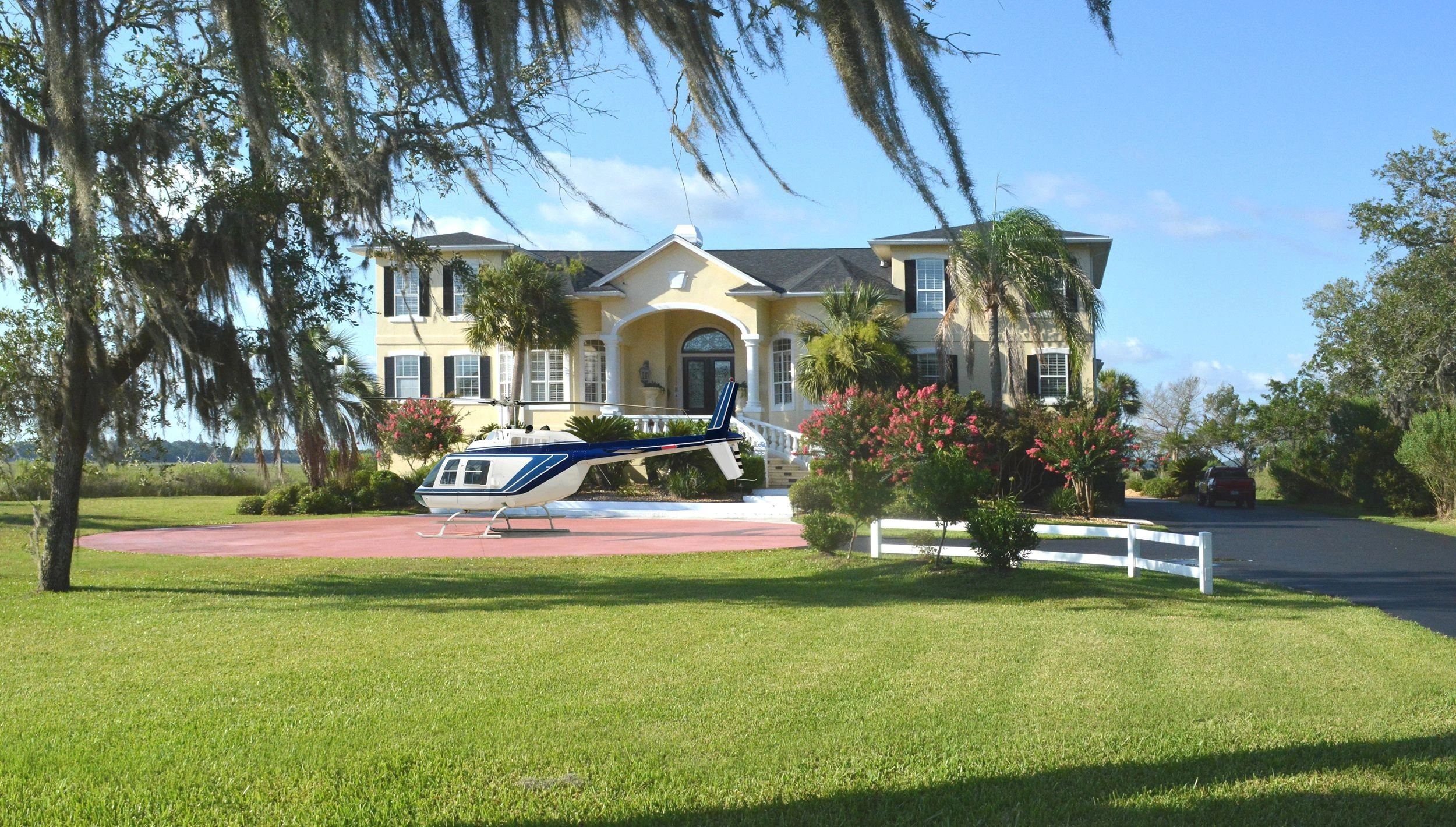 Front of home with helicopter out front