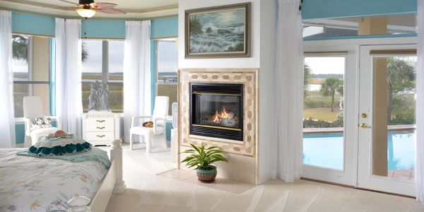 Master bedroom with fireplace and doors to pool deck