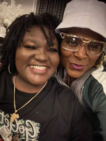 Two women smiling close together for a selfie.