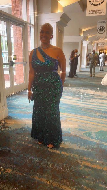 Woman in a sparkling blue evening gown.