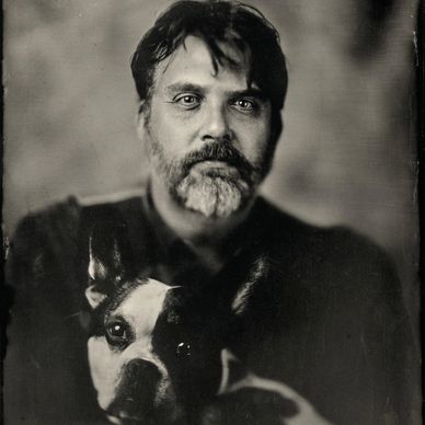Black and white photo of a Man with a dog 