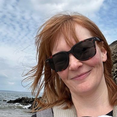 Woman on the beach wearing sunglasses 