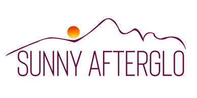 Sunny AfterGlo logo with a face upward facing like mountains and a setting sun above the eye.