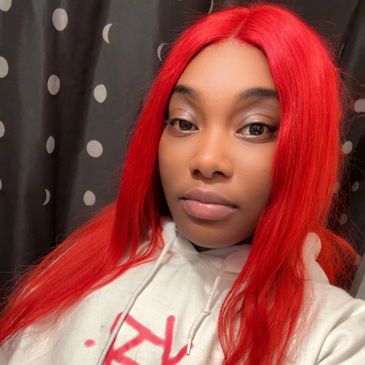 Woman with long bright red hair taking a selfie.