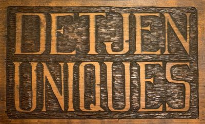 Wooden sign reading 'DETJEN UNIQUES'.