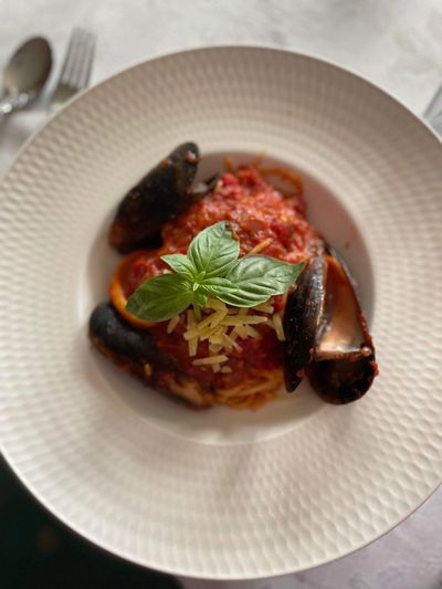 spaghetti marinara in a white bowl