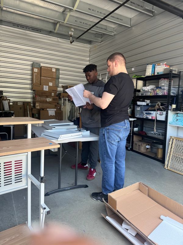 Two volunteers reading directions.