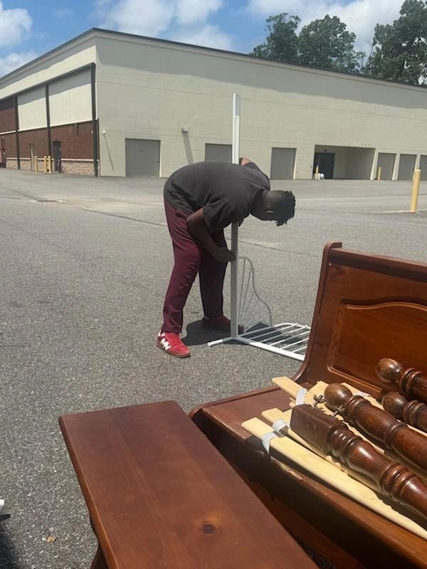 Volunteer buiding a bed frame.