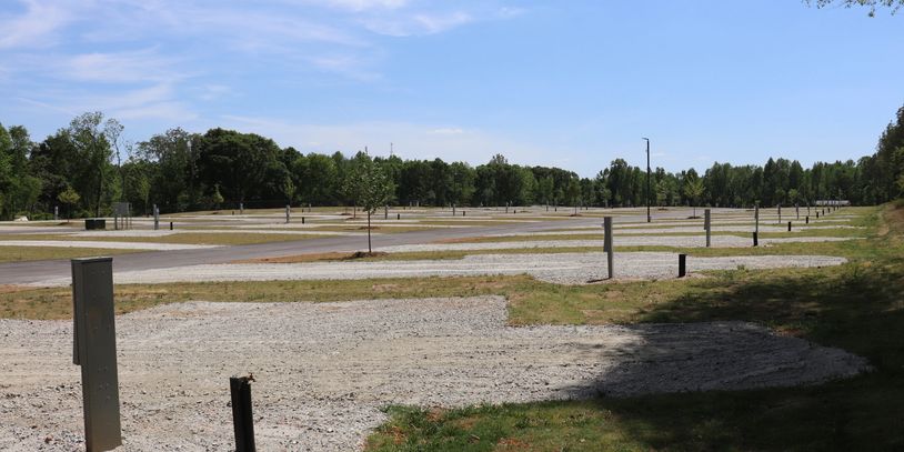 Empty campground with multiple RV slots on a sunny day.