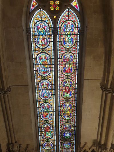 Intricate stained glass window with religious figures.